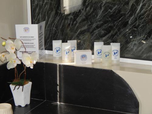 a group of candles on a counter with flowers at Posada de los Pajaros in Punta del Este