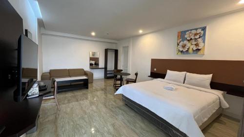 a hotel room with a bed and a living room at The Royal Gisting - Heritage Hotel in Banjarnegeri