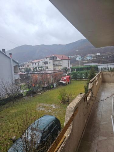 a car parked in a yard next to a fence at Kristina Guesthouse in Librazhd