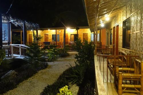 a patio of a restaurant at night with lights at New Village Lodge in Oslob