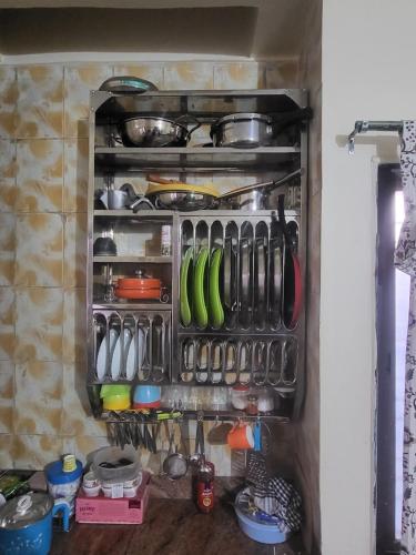 a kitchen drawer filled with lots of cooking utensils at Hari Prasad Homestay in Shirdi