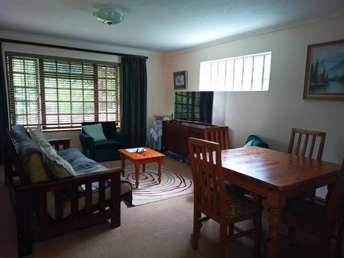 a living room with a table and a dining room at Cosy Cottage in Sedgefield