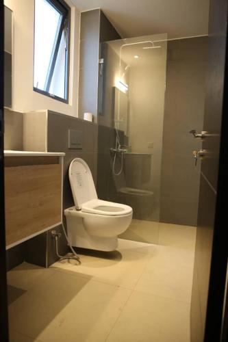 a bathroom with a toilet and a sink and a shower at Bustani Villa in Mchamba Wima