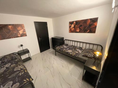 a bedroom with two beds and paintings on the wall at Second home apartment - silver in Kustići