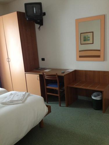 a hotel room with a desk and a bed at Hotel Lario in Mezzegra
