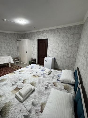 a large bed in a room with rocks on it at Chorsu Old City in Tashkent