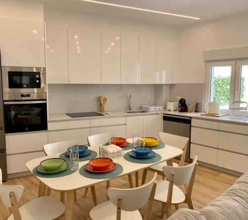 a kitchen with a table with plates on it at Apartamentos Ézaro Beach in Dumbría