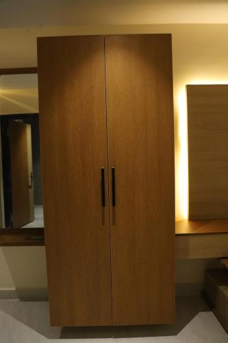 a large wooden cabinet in a room at Hotel N Grand in Miriālgūda