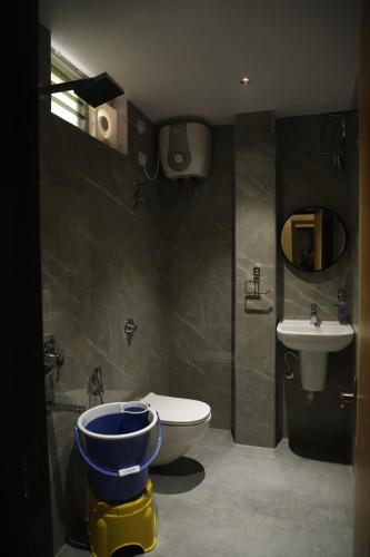 a bathroom with a toilet and a sink at Hotel N Grand in Miriālgūda