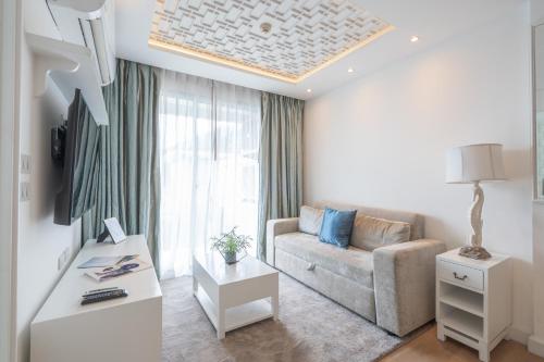 a living room with a couch and a table at Seavale patong phuket in Patong Beach