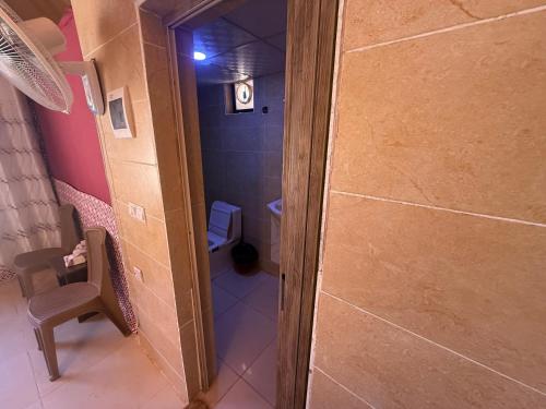 a small bathroom with a shower and a toilet at Starry Nights Luxury Camp in Wadi Rum