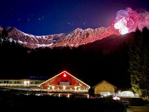 een schuur 's nachts met een vuurshow in de bergen bij Sweet Cherry - Boutique & Guesthouse Tyrol in Innsbruck
