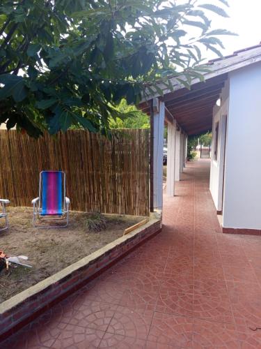 a blue chair sitting in a yard next to a fence at Forza e avanti in Santa Teresita