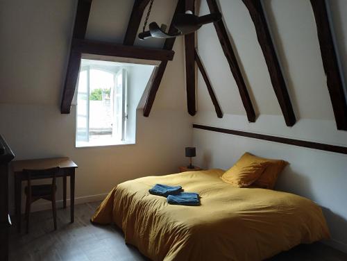 a bedroom with a bed in a room with a window at Chambres d'hôtes l'arche d'Yvann in Campuac