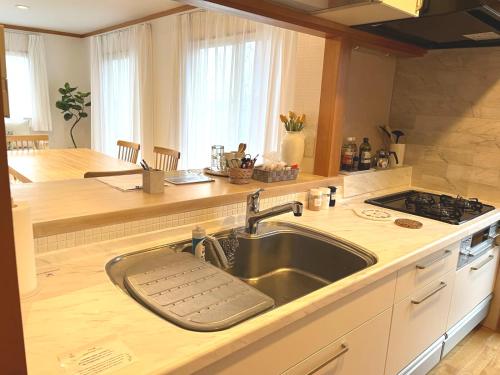a kitchen with a sink and a counter top at Cozy House Azumino in Azumino