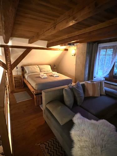a small bedroom with a bed and a couch at Little Cottage No.100 in Vidochov