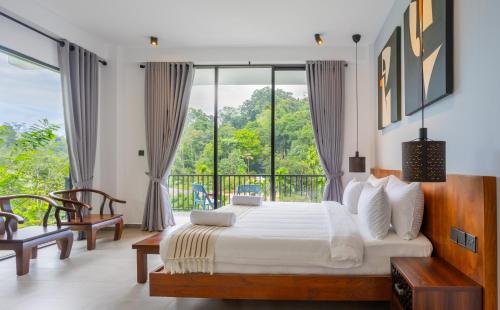 a bedroom with a large bed and a balcony at Namara Green Ella in Ella