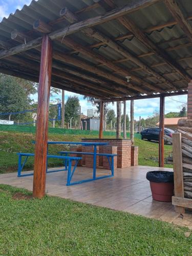a picnic table under a pavilion in a park at Recanto do Daniel in Irati
