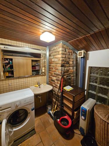 a bathroom with a washing machine and a sink at Bergbauer Offenburg in Pöls