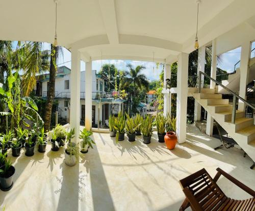 a patio with a bunch of potted plants and stairs at Villa Calton 32 Villa in Weligama Bay in Weligama