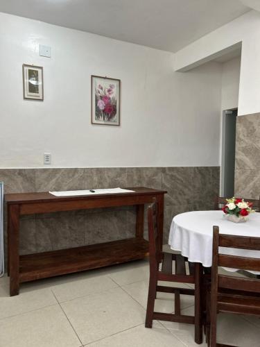 a dining room with a table and a table and chairs at Casas do Matteo - 2ª Praia in Morro de São Paulo