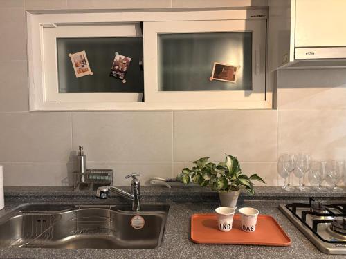 a kitchen counter with a sink and two windows at 스테이아지트 in Seoul