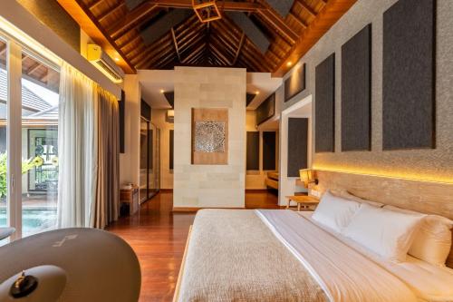 a bedroom with a large bed in a house at Aresty 3 Bedroom Villa Canggu in Canggu