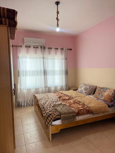 a bedroom with a bed and a window at Seaview horizon apartment in Sowayma