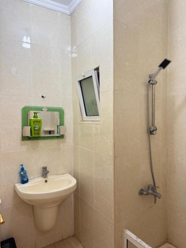 a bathroom with a sink and a toilet and a shower at Seaview horizon apartment in Sowayma