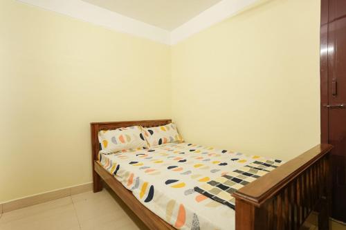 a small bedroom with a bed in a room at Ashu Homestay Nest 1 in Pondicherry