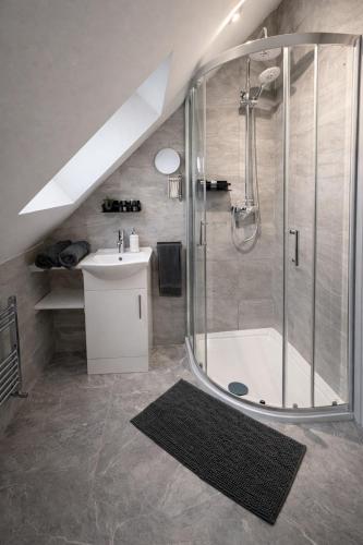 a bathroom with a shower and a sink at Beautiful cosy attic studio flat king size bed in central Beeston in Nottingham in Beeston