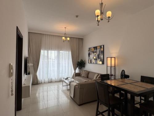 a living room with a couch and a table at Silicon Heights II in Dubai