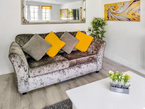 a living room with a couch with yellow pillows at The Haven Lodge in Clifton