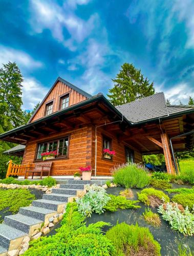 a log cabin with stairs leading up to it at Drevenica Lesanka in Belá
