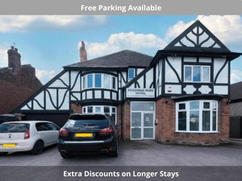 a large house with cars parked in front of it at OYO The Pickering Park Hotel in Hull