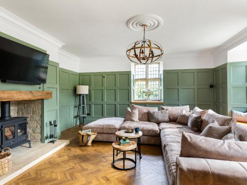 a living room with a couch and a fireplace at Killerby Old Hall - Uk47711 in Cayton