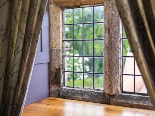an open window in a room with a wooden floor at Killerby Old Hall - Uk47711 in Cayton
