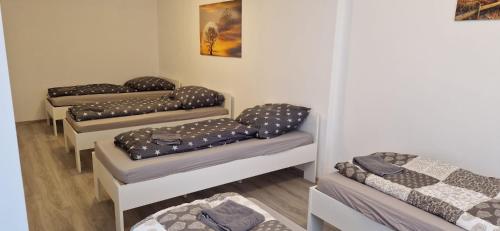 a group of four beds in a room at Sson-Appartments in Detmold