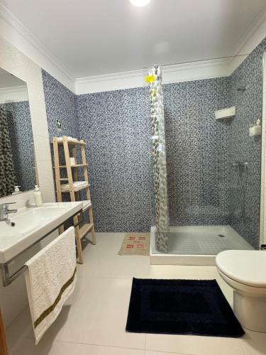 a bathroom with a shower and a sink and a toilet at Old Zone Apartment - 1º B in Bicas