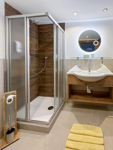 a bathroom with a shower and a sink at Hotel Garni Tyola in Ischgl