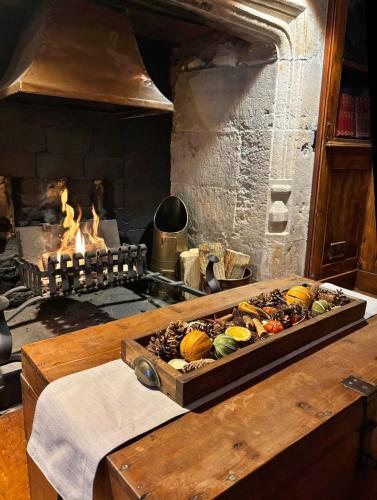 a tray of vegetables on a table with a fireplace at The Bugle Coaching Inn in Yarmouth