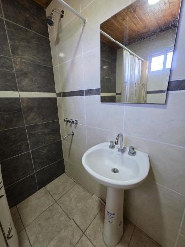 a bathroom with a sink and a mirror at Complejo Balcarce in San Rafael