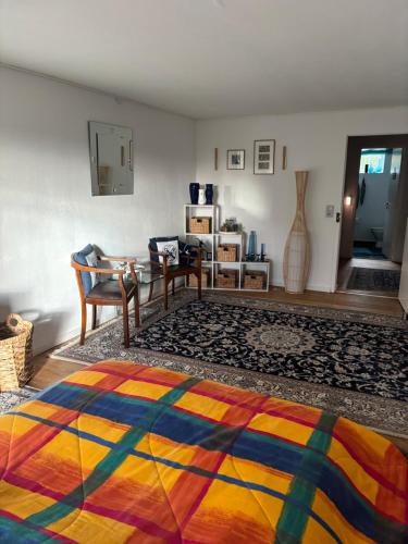 a room with a bed and a table and a couch at Gästewohnung Karin in Fjelby