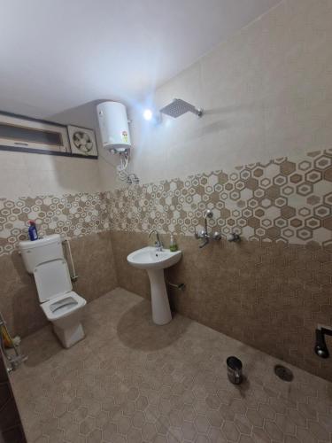 a bathroom with a toilet and a sink at Bikaner House in Bikaner