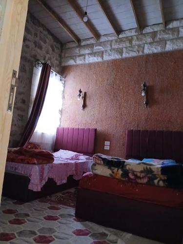 a room with two beds and a window in it at الشاميه سانت كاترين in Saint Catherine