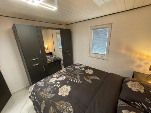a bedroom with a bed and a couch and a mirror at Second home apartment - gold in Kustići