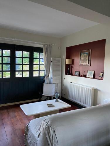 a bedroom with a bed and a table and a chair at A la Colline de la bergerie in Cambo-les-Bains