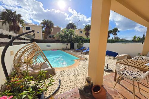 a patio with a swimming pool and a table and chairs at SV Villa Burgau in Burgau