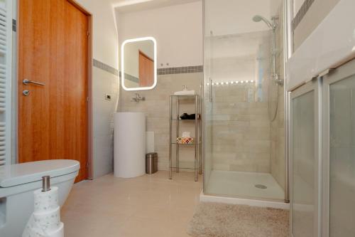a bathroom with a shower and a toilet and a sink at Trieste - Villa Prosecco in Prosecco