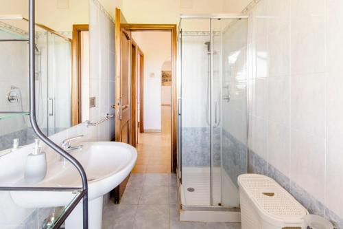 a bathroom with a tub and a sink and a shower at Le Anfore in Marino